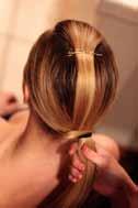 Pull this piece forward and separate from the rest of the hair. Step 2: Pull remaining hair back into a low ponytail.