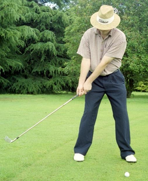 ) so you're facing the clubhead. This will put you in a similar position as if you were setting up to a shot.