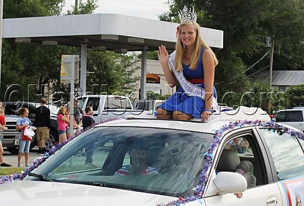Mackenzie Henderson of the Imperial Beauties of America rides in the Independence Day Parade in Williston on Friday (July 1).