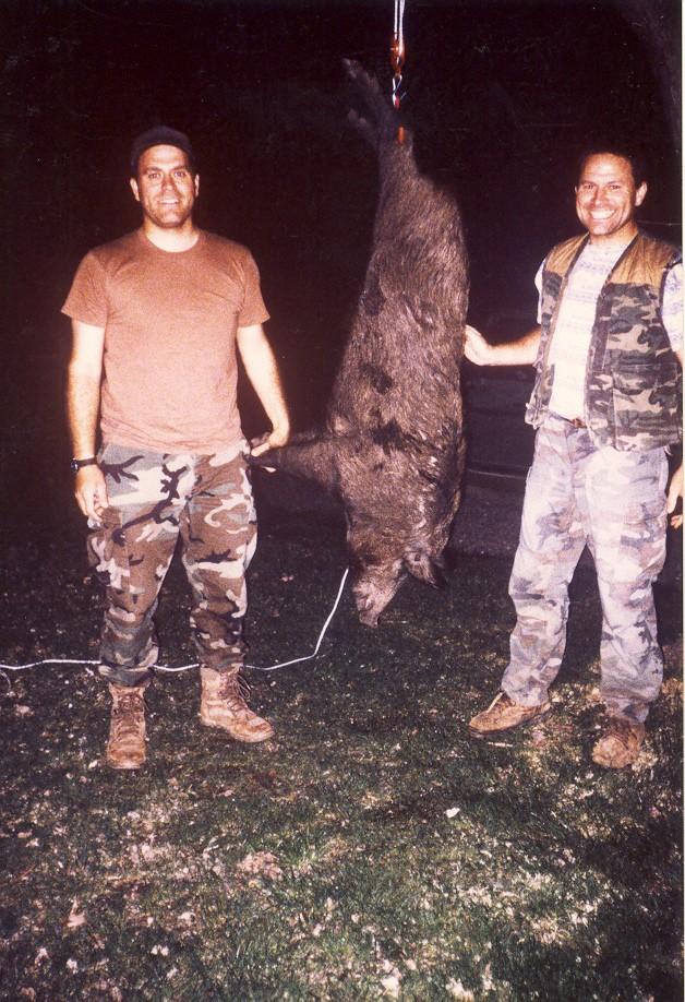 Fort Leonard Wood feral hog hunters Kevin and Kenton Lohraff with a harvested animal in 2001.