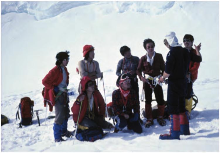 Figure 4. During the 1980s and early 1990s, the NPS undertook a major outreach effort to foreign climbers. Here, in a 1982 photo, ranger Roger Robinson speaks to a group of Japanese climbers.