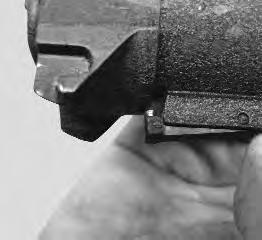 There is a hook shaped projection on the buttstock assembly that fits into a key hole shaped slot in the forward end of the receiver.