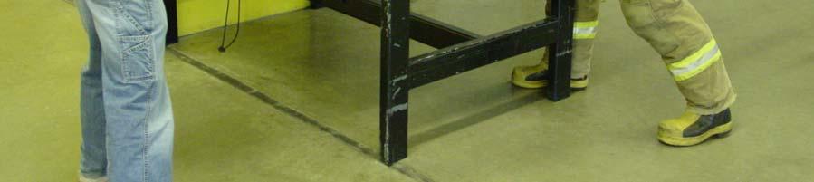 The table is made of steel and is placed against a wall for stability.