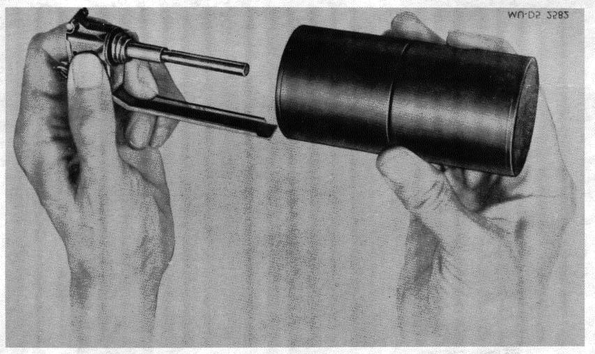 TM 9-1330-200-12/OP 3833 1 st Rev. Vol 2/TM 1320-12/1A Figure 2-7. Screwing offensive grenade body onto fuze. (6) Remove tape from vent in nose of Smoke Rifle Grenade M23 Series just prior to firing.
