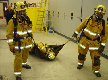 A tool drag enables rescuers to be spaced apart while allowing a secure place to grip the downed firefighter. A tool such as a Halligan bar or closet hook works best for the tool drag.