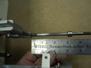 Measure the distance from the back of the strut to the front of the drive dog. Subtract 3/8 inch from this measurement.