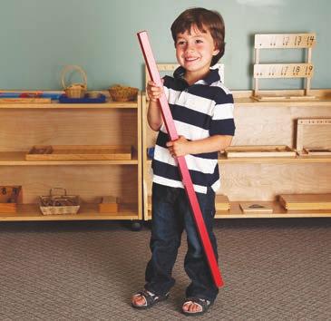 Child carrying the longest Red Rod Montessori Moment Dr.