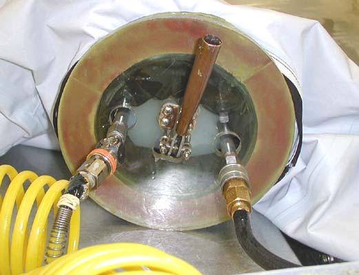 Carefully seal the neck by clamping the plates together with the lever, and attach the air hose and gauge hose to the