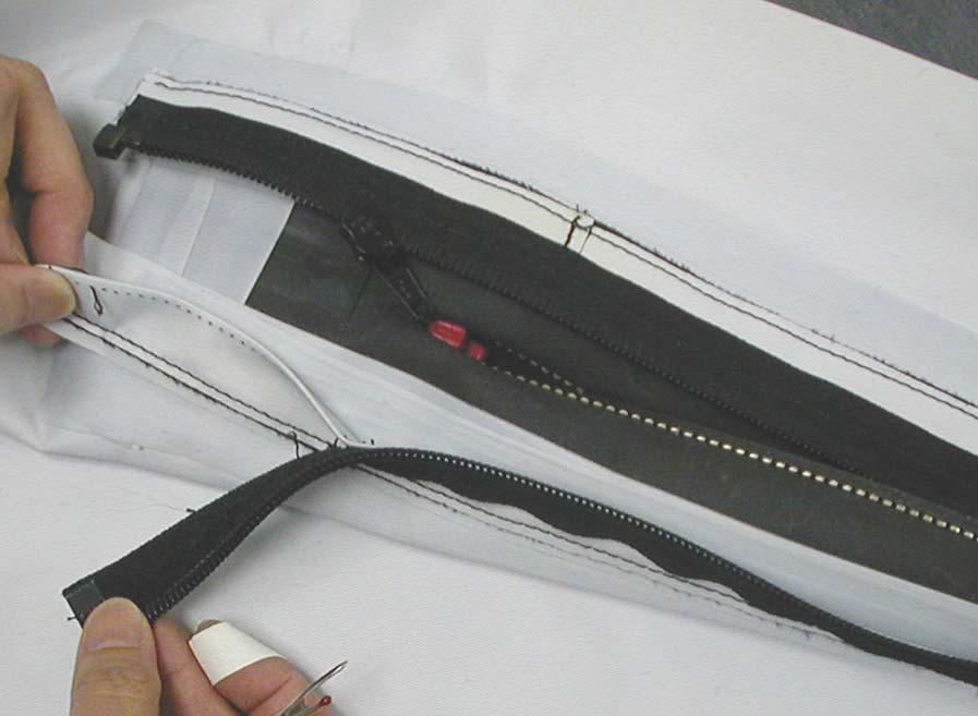 c. Remove the broken zipper by gently pulling it away. Figure 35. Step c.