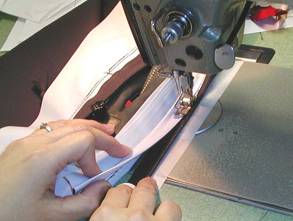 Align the edge of the fabric closely to the edge of the replacement zipper tape and sew 1 / 8