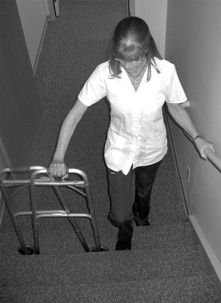 Repeat going up each step, starting with the walker, strong leg, and then weak leg. At the top of the stairs, unfold the walker and place it on the landing.
