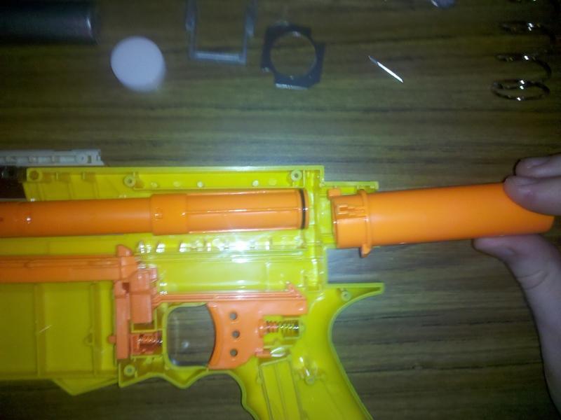 Carefully remove the plastic trigger catch and