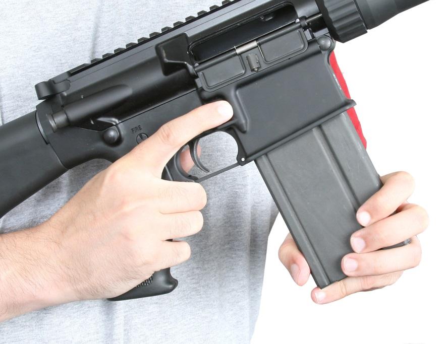 INSERT THE MAGAZINE FULLY INTO THE RIFLE THEN TUG DOWNWARD ON IT TO ASSURE IT S SECURELY LOCKED INTO THE RIFLE. 3. Pull down on the magazine slightly to make sure that it is locked in place. 4.