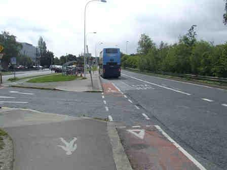 left with the traffic. The footway will continue straight towards the bus stop.