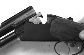 Then remove the forend from the barrel by pulling outward on the mechanical lever in the lower midsection of the forend and tipping the forend out and away from the barrel. (See Picture 16). 2.