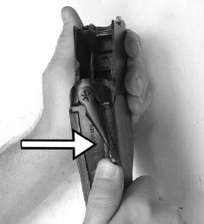 Holding the barrels with the other hand, engage the lower locking lug located on the lower portion of the barrels with the receiver.