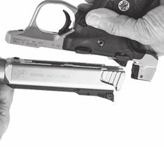them together and away from the grip frame (FIGURE 30). NOTE: Once lifted clear of the frame, the bolt is free to slide out the rear of the receiver.