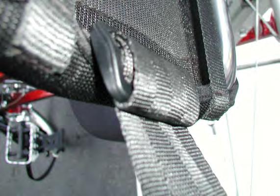 Repeat this process on both the right and left side of each seat on each bike. Figure 15 16) Insert the end of nylon strap back through the tri-glide as shown in figure 16.