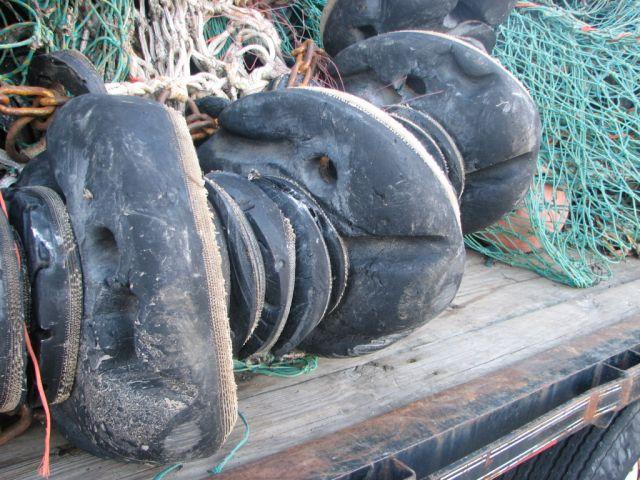 6). The curvature of the sweep allows only the middle rollers to rotate; those located along the shoulders of the trawl are dragged laterally over the seabed.