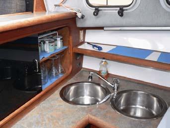 To port down two steps from the salon opposite the helm is the galley area.