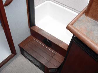 Forward, steps lead down from the saloon to the forward stateroom and head. The forward stateroom includes two large V-berths with an insert.