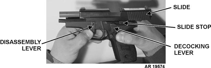 h. Push slide to rear and hold. Push slide stop UP to lock slide in place. i. Holding weapon in right hand, use left thumb to rotate disassembly lever UPWARD until it stops.