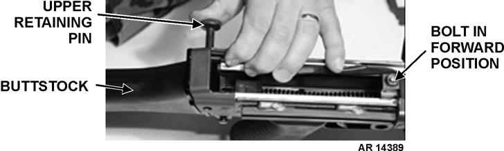 f. Pivot buttstock and buffer assembly UPWARD into position and push upper retaining pin to the RIGHT to secure.