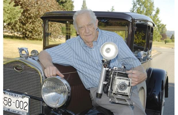 Ralph Bower poses with his original Vancouver Sun news camera and his 1931 Ford