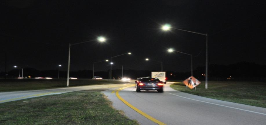 Conventional High Pressure Sodium (HPS) street lighting present along both