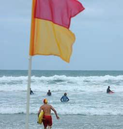 Beach safety Always swim between the flags Any beach can be dangerous. Beach-goers should be careful and always swim between the red and yellow flags, which indicate that the beach is patrolled.