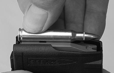 Pull the charging handle completely to the rear until the bolt carrier locks back. Return the charging handle to the latched position and rotate the safety selector to SAFE (see page 14). 2.