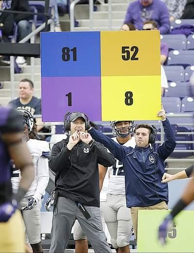A play is signaled from the Utah State sideline during a game against Washington earlier