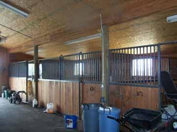 The north wing of the building is the shop/garage with automatic overhead doors. The south wing is a 3 stall barn with automatic overhead door.