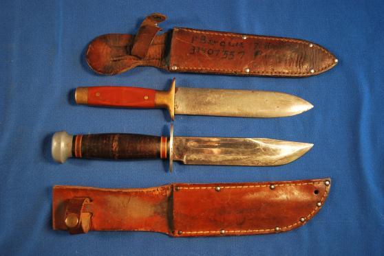 43. Two WWII Fighting Knives The Sidney R. Baxter & Co, Boston, U.S.A. double edged knife measures 10 1/2" in length with a 6 3/8" blade. Has a brass handle with plastic grips; one is slightly loose.