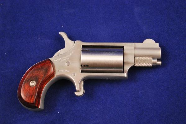 North American Arms Black Powder Stainless Mini Cap & Ball Revolver Serial # K1704, 22 caliber, 1" barrel, with near excellent bore. The finish on the revolver and grips is very good.