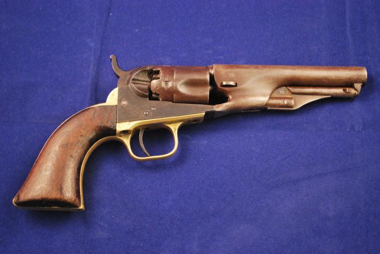 The Colt 1862 model is considered by many collectors as the ultimate in streamlined design by Colt during the percussion period. One piece walnut grips and brass frame and back strap.