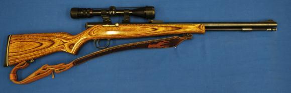 The metal surfaces are in very good condition, and the monte carlo stock with rubber butt pad is in very good+ condition. There is a Powerline 3-9x32mm scope mounted on the rifle in tip-off rings.