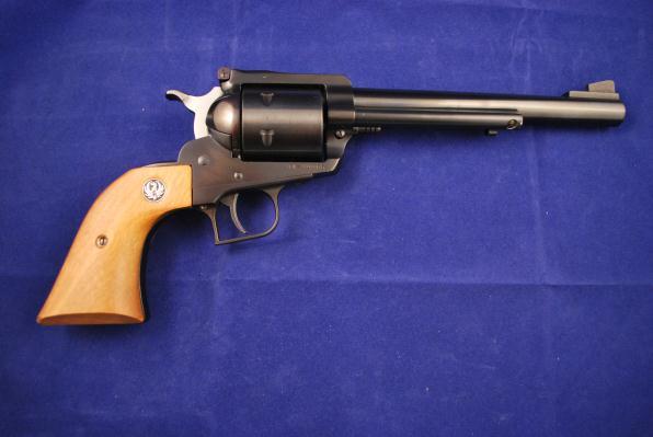 This six-shot revolver has the light color wooden one-piece grips with logo. Adjustable rear and fixed front ramp sights. The cylinder has a light drag line.