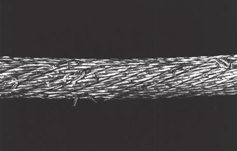 11 shows the cross-section of a rotation-resistant hoist rope 36x7. Fig. 12 shows the external surface of such a rope after a few months of service.