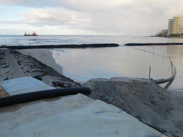 The pipeline was routed over a breakwater into a dewatering basin constructed in the east Kuhio Beach swim basin.