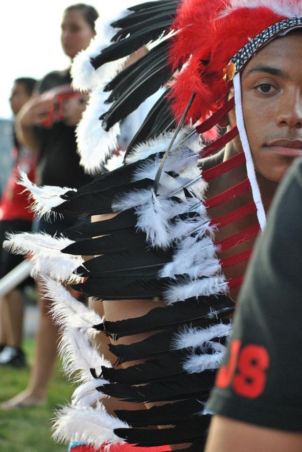 EXAMPLE: Scarlet Pride. Adorned in a head dress, 2012 graduate Salat Jones takes in the atmosphere at the first tailgate of the season on Sept. 1.