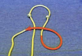 Take your piece of rope and fold it in half. At the center point, tie a simple overhand knot. Snug the knot up.