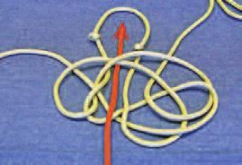 9. Then take the end of the same strand and go through the center under the two pieces of rope at the top of the loop.