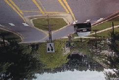 A standard traffic circle cannot control speeds on the top of a T-intersection, so curb extensions may be added on the approaches to achieve some horizontal deflection.