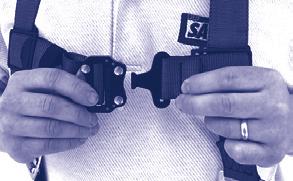 Parachute Buckle: Pass webbing under buckle and over roller and down between roller and frame. Pull web end to tighten. Three inches of web must extend past buckle.