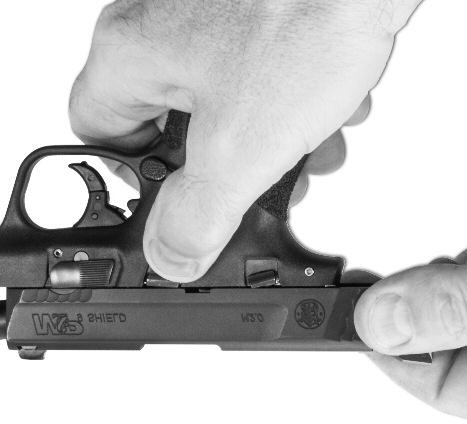 FIGURE 5 Point the muzzle in a safe direction, grasp the serrated sides of the slide from the rear with the thumb and fingers as shown (FIGURE 6), and briskly draw the slide fully rearward