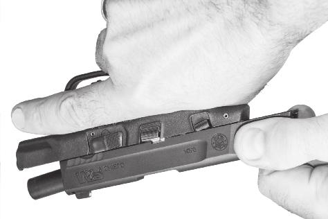 Make sure your finger is off the trigger and out of the trigger guard. Depress the magazine release, and remove the magazine (FIG- URE 28).