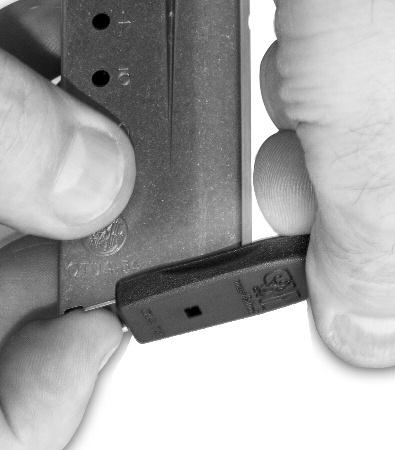 The seven round magazine floorplate catch needs to be depressed until it is bottomed out (and the guides are visible - FIG- URE 59) before sliding floorplate forward 2.