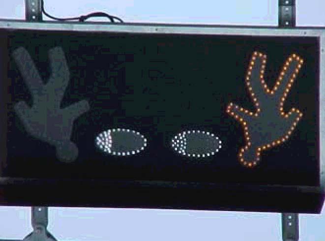 The eyes and pedestrian symbol displays were populated with yellow (590 nm) LEDs. The garage signal was mounted in the lower portion of the concrete header wall just above the sidewalk.