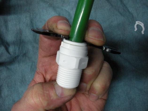 Using the tubing removal assist tool, press the proper size opening against the collet of the fitting and while holding the collet up against the fitting securely, pull on the tube until it is
